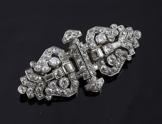 A 1930s Art Deco white gold and diamond double dress clip/brooch, 2in.